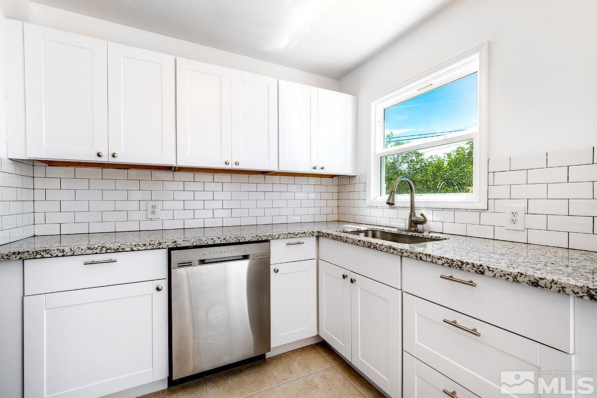 1525 Keystone Avenue Reno, NV 89503 - Photo 8 of 16 a kitchen with granite countertop white cabinets and white appliances
