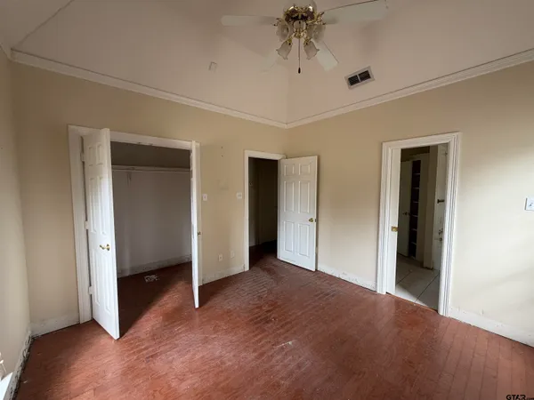 a view of a livingroom with a ceiling fan and window