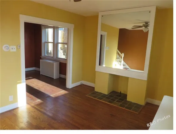 hallway with wooden floor and windows