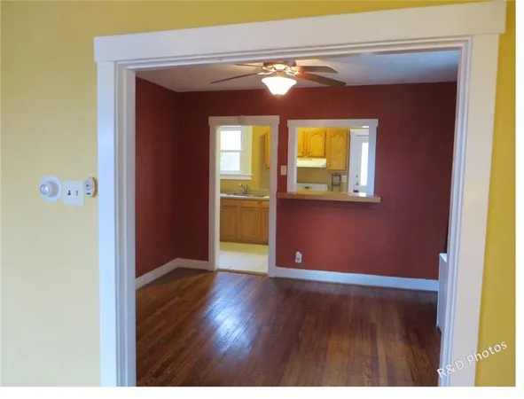a view of a room with wooden floor and windows