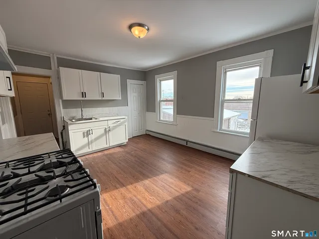 a kitchen with granite countertop a stove and a refrigerator