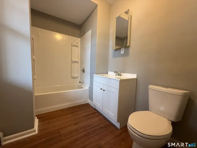 a bathroom with a toilet a sink and bathtub