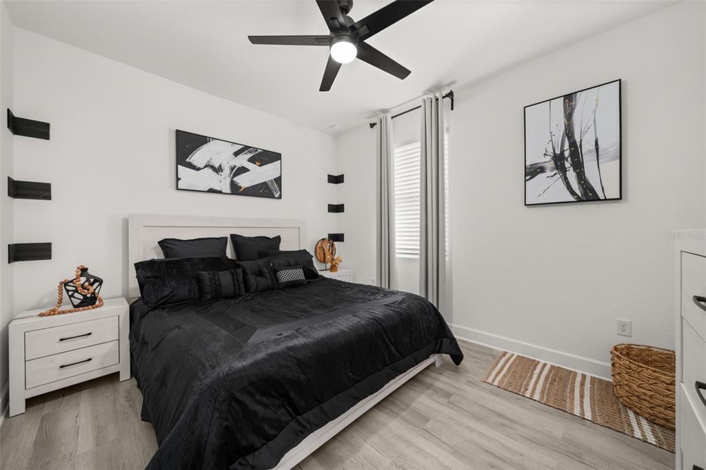 1113 Caloosa Ridge Way Babson Park, FL 33827 - Photo 31 of 77 a bedroom with a bed and wooden floor