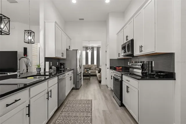 a living room with furniture wooden floor and a large window