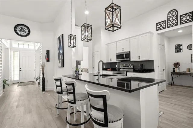 a view of a a dining room with furniture window and wooden floor