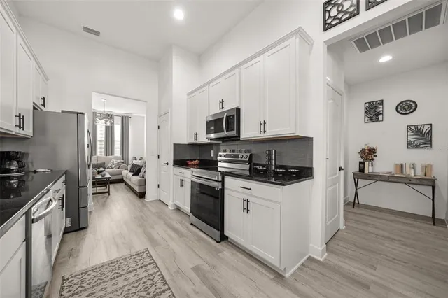a bedroom with two beds and a chandelier