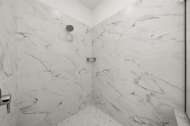 a bedroom with a bed and a chair