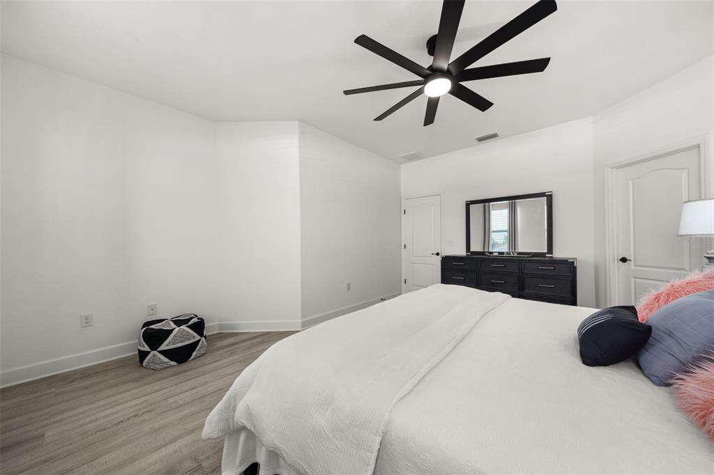 1113 Caloosa Ridge Way Babson Park, FL 33827 - Photo 56 of 77 a bedroom with a bed and a chandelier