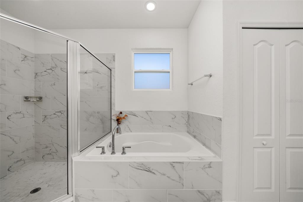 1113 Caloosa Ridge Way Babson Park, FL 33827 - Photo 57 of 77 a bathroom with a bathtub and shower