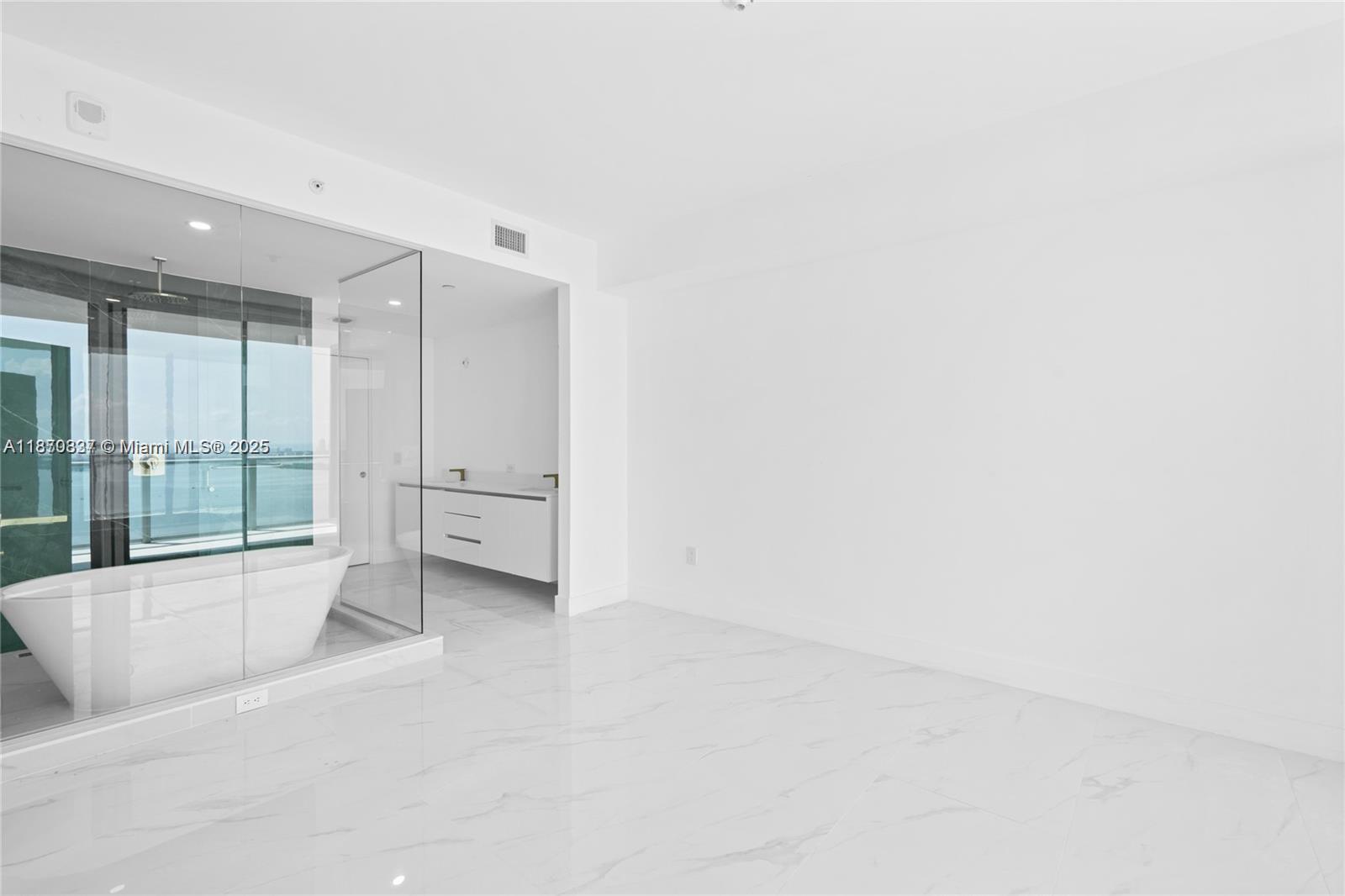 700 Northeast 24th Street, Unit 4704 Miami, FL 33137 - Photo 6 of 13 an empty room with large windows