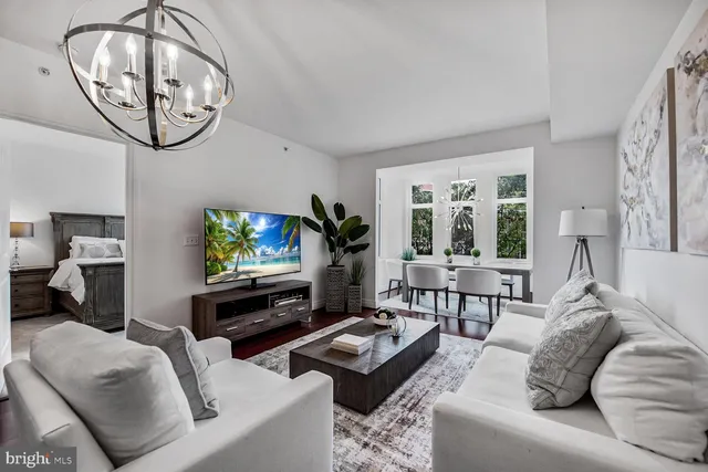 a living room with furniture a window and a flat screen tv