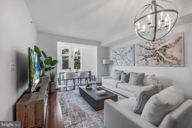 a living room with furniture a window and a flat screen tv