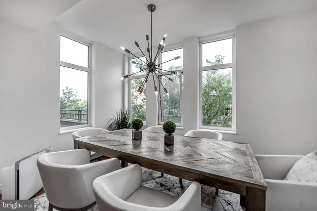 a dining room with furniture a window and a chandelier