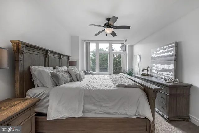 a bedroom with a large bed and a window