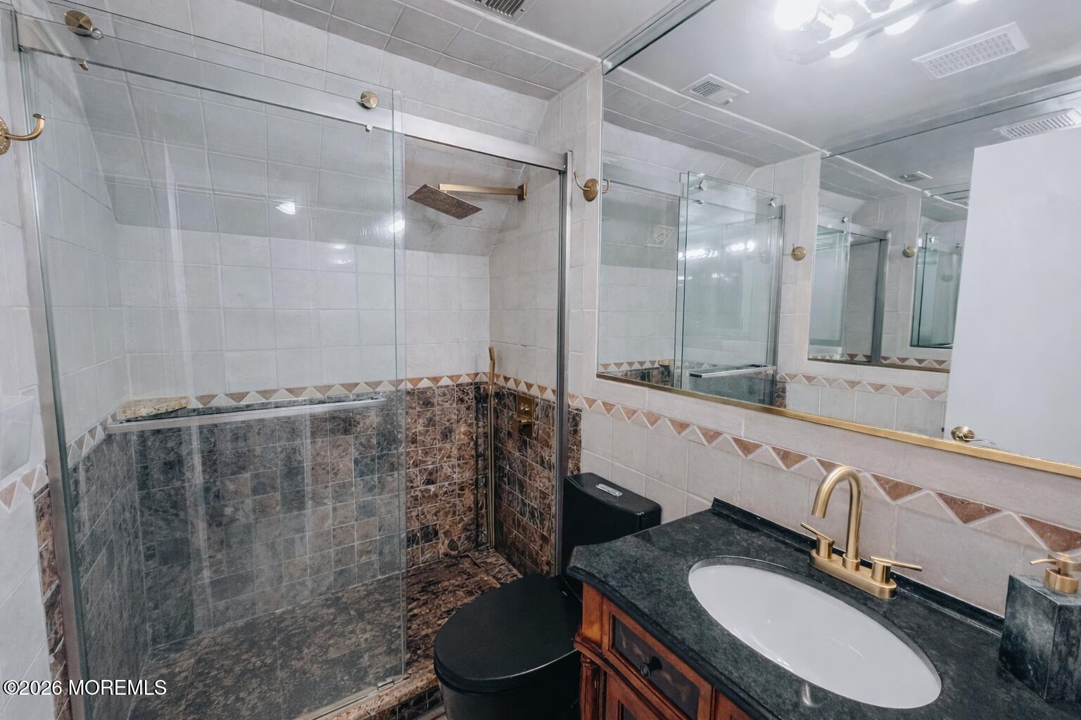 6 Hillcrest Road Manalapan, NJ 07726 - Photo 3 of 6 a bathroom with a granite countertop sink toilet a mirror a vanity and shower
