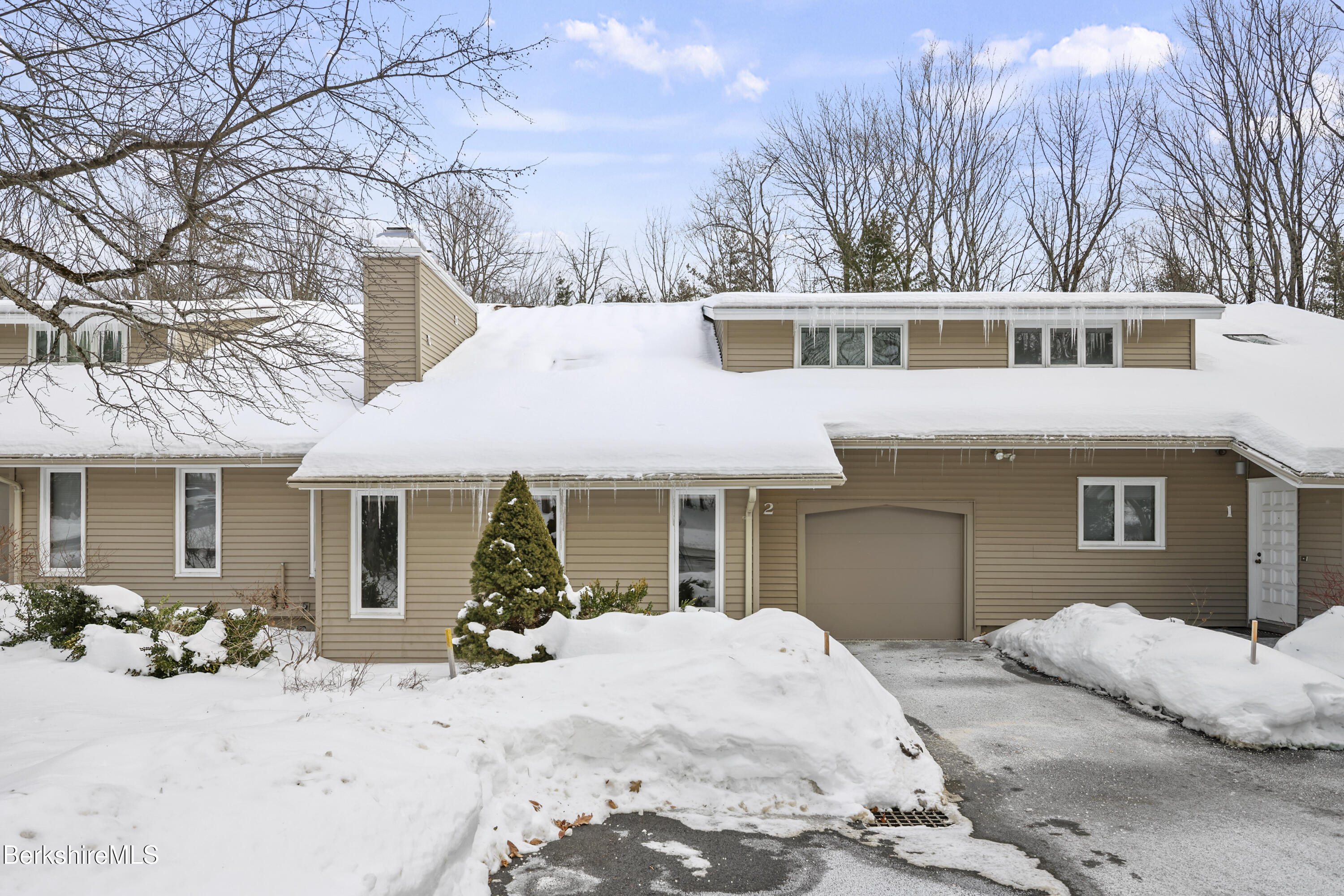 30 Clifden Court, Unit 2 Lenox, MA 01240 - Photo 5 of 40 a view of a house with a yard covered in snow