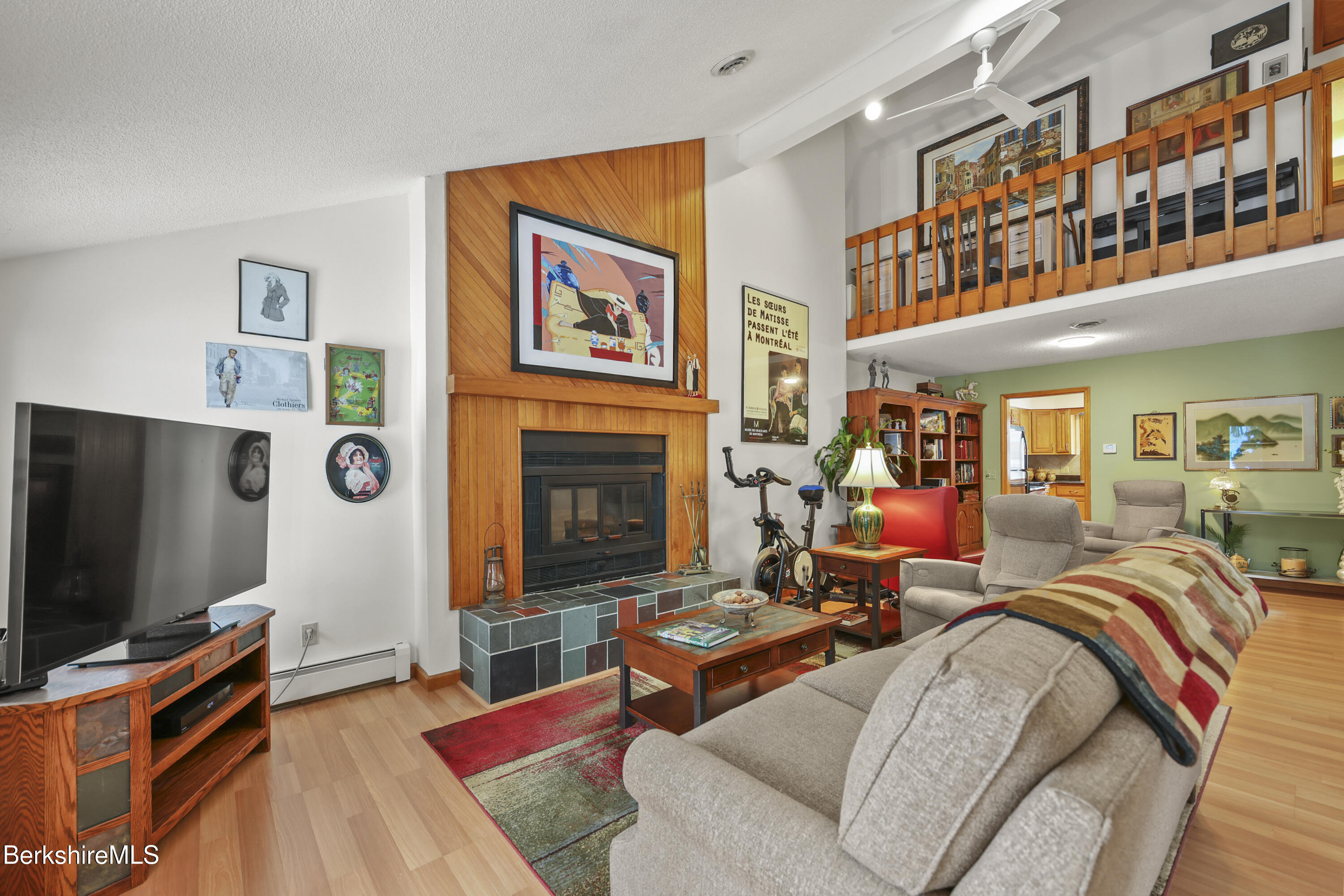 30 Clifden Court, Unit 2 Lenox, MA 01240 - Photo 7 of 40 a living room with furniture a flat screen tv and a fireplace