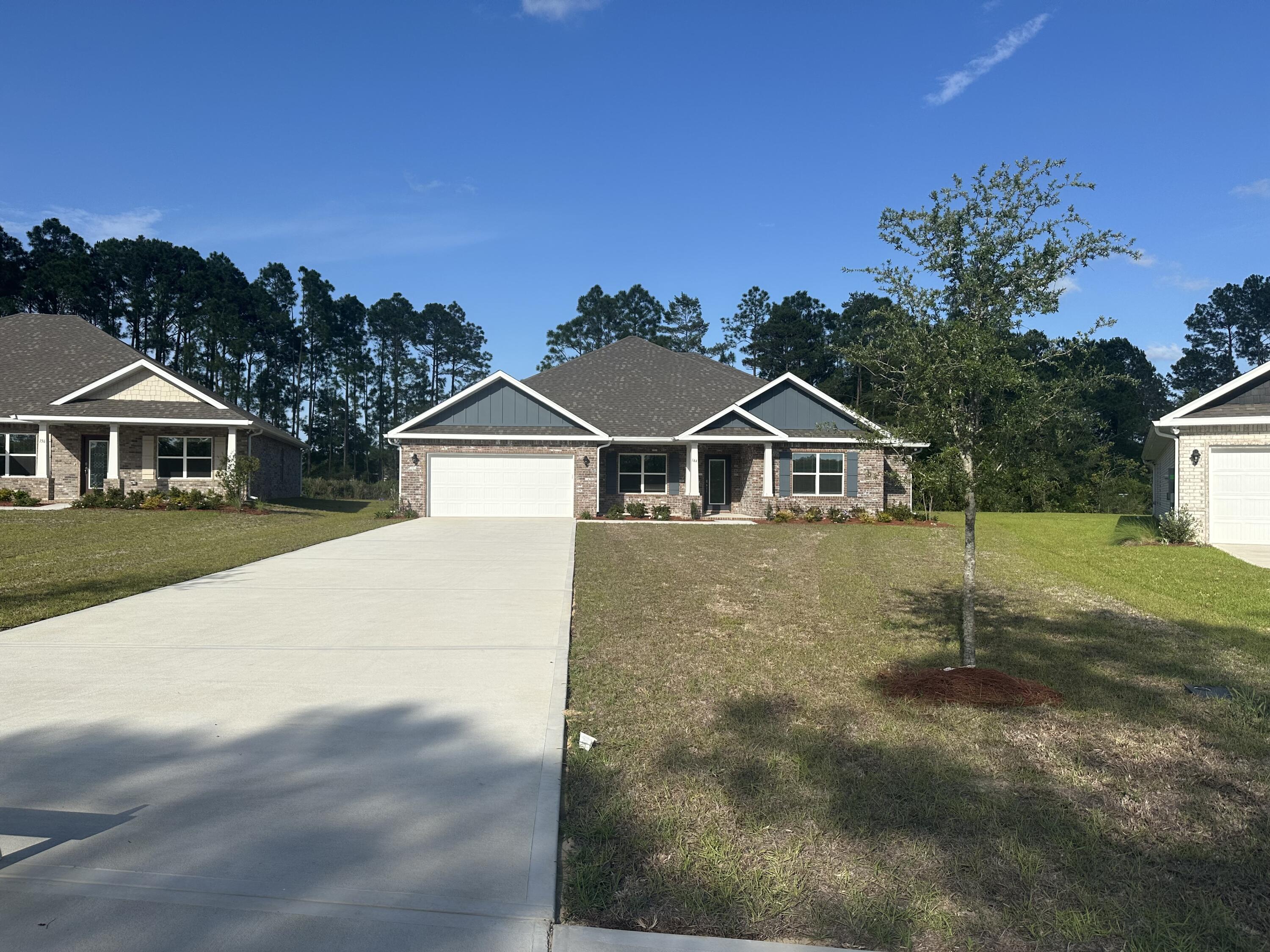 144 Bentgrass Road South Freeport, FL 32439 - Photo 2 of 8 a house with trees in the background