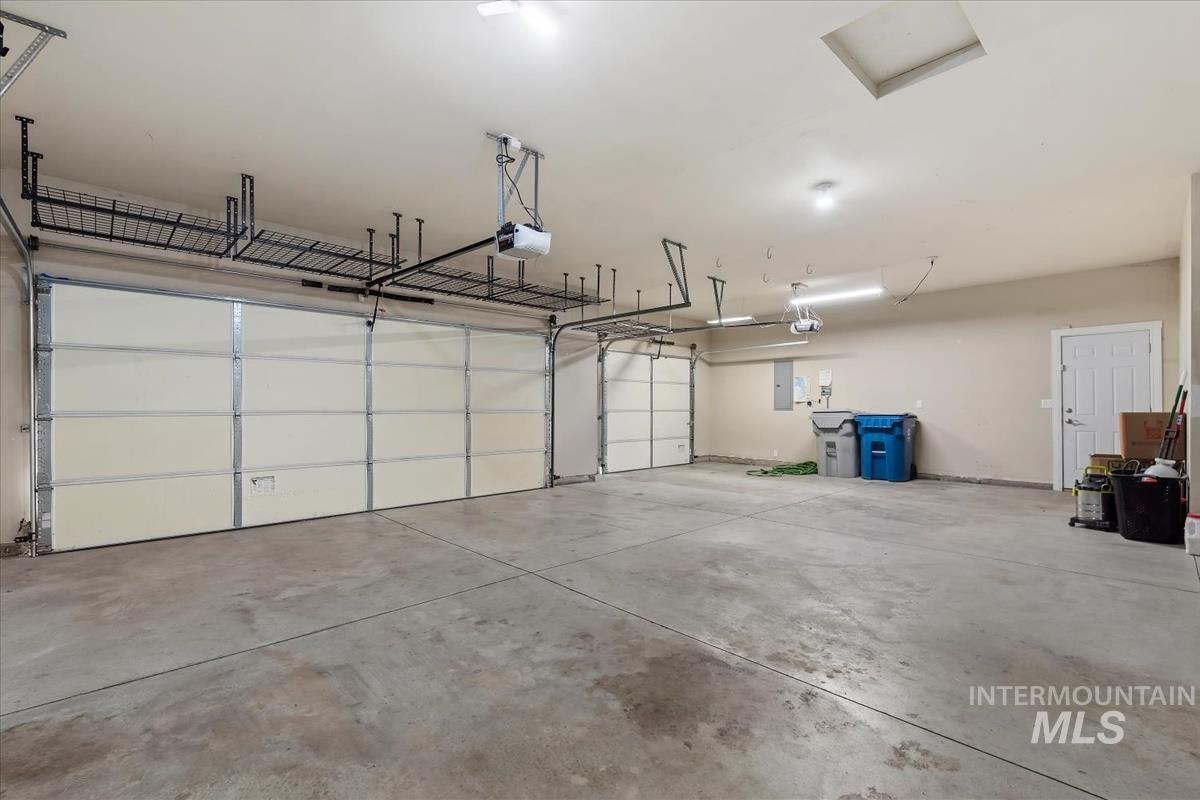 640 Southwest Miner Street Mountain Home, ID 83647 - Photo 24 of 35 Spacious garage featuring two overhead doors, concrete flooring, and an additional side access door