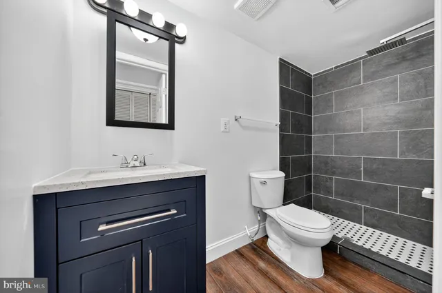 a bathroom with a sink toilet and shower