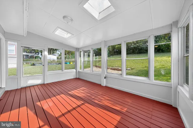 a view of wooden floor and windows in a room