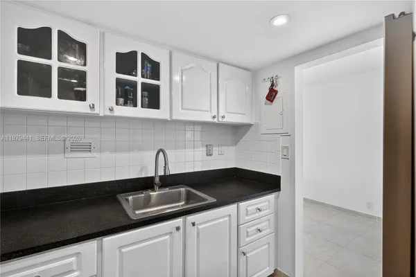 a kitchen with stainless steel appliances a sink and cabinets