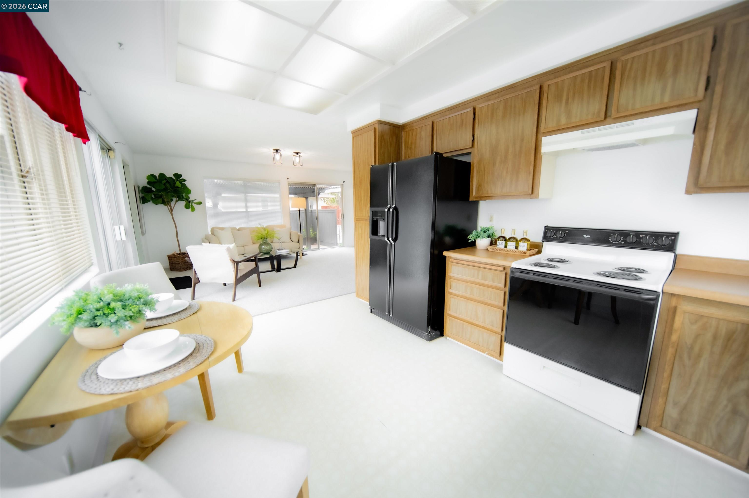 5581 Gonzalez Court Concord, CA 94521 - Photo 19 of 43 a living room with stainless steel appliances a couch a table a rug and a window