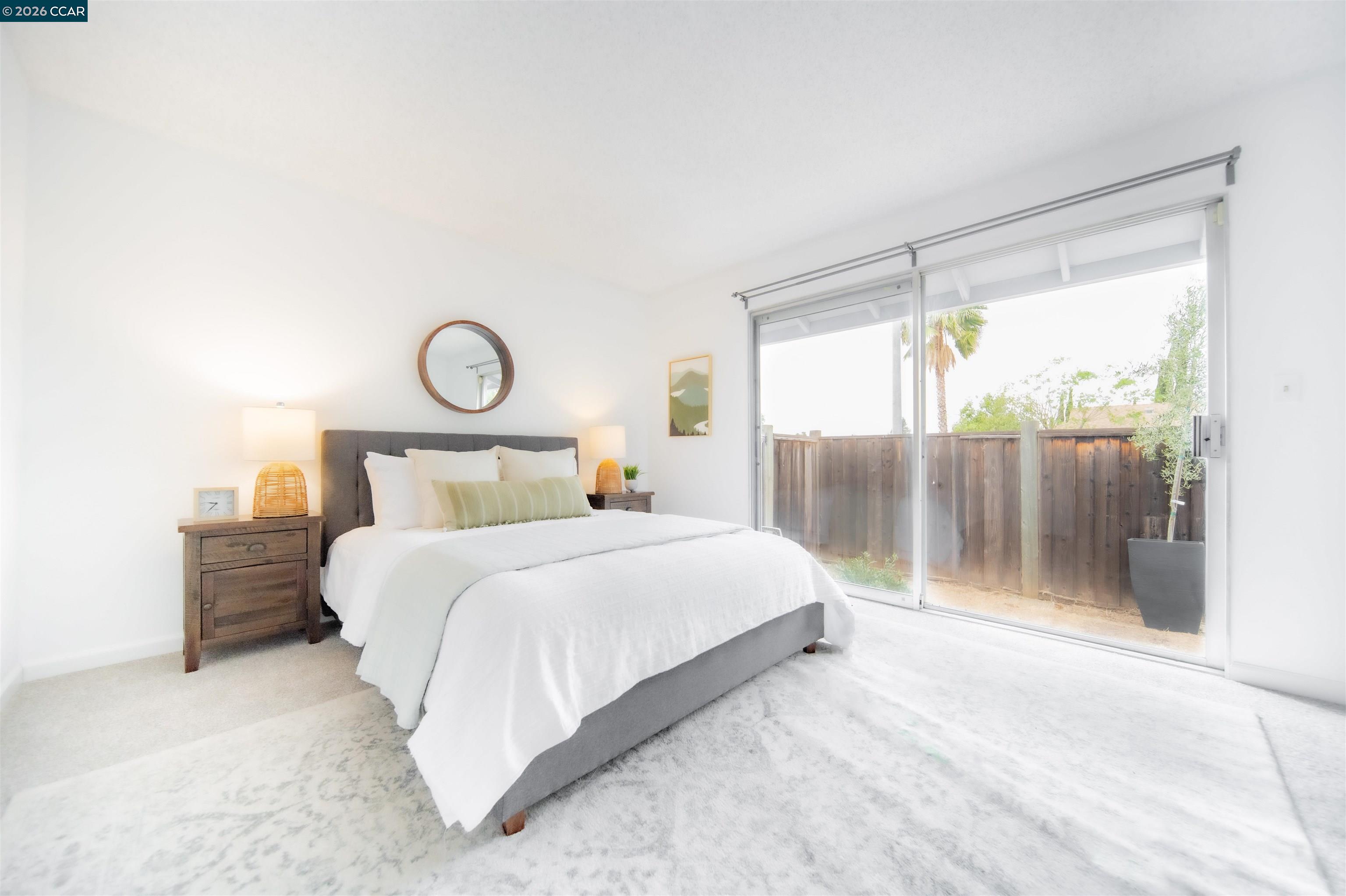 5581 Gonzalez Court Concord, CA 94521 - Photo 25 of 43 a bedroom with a large bed and a shower