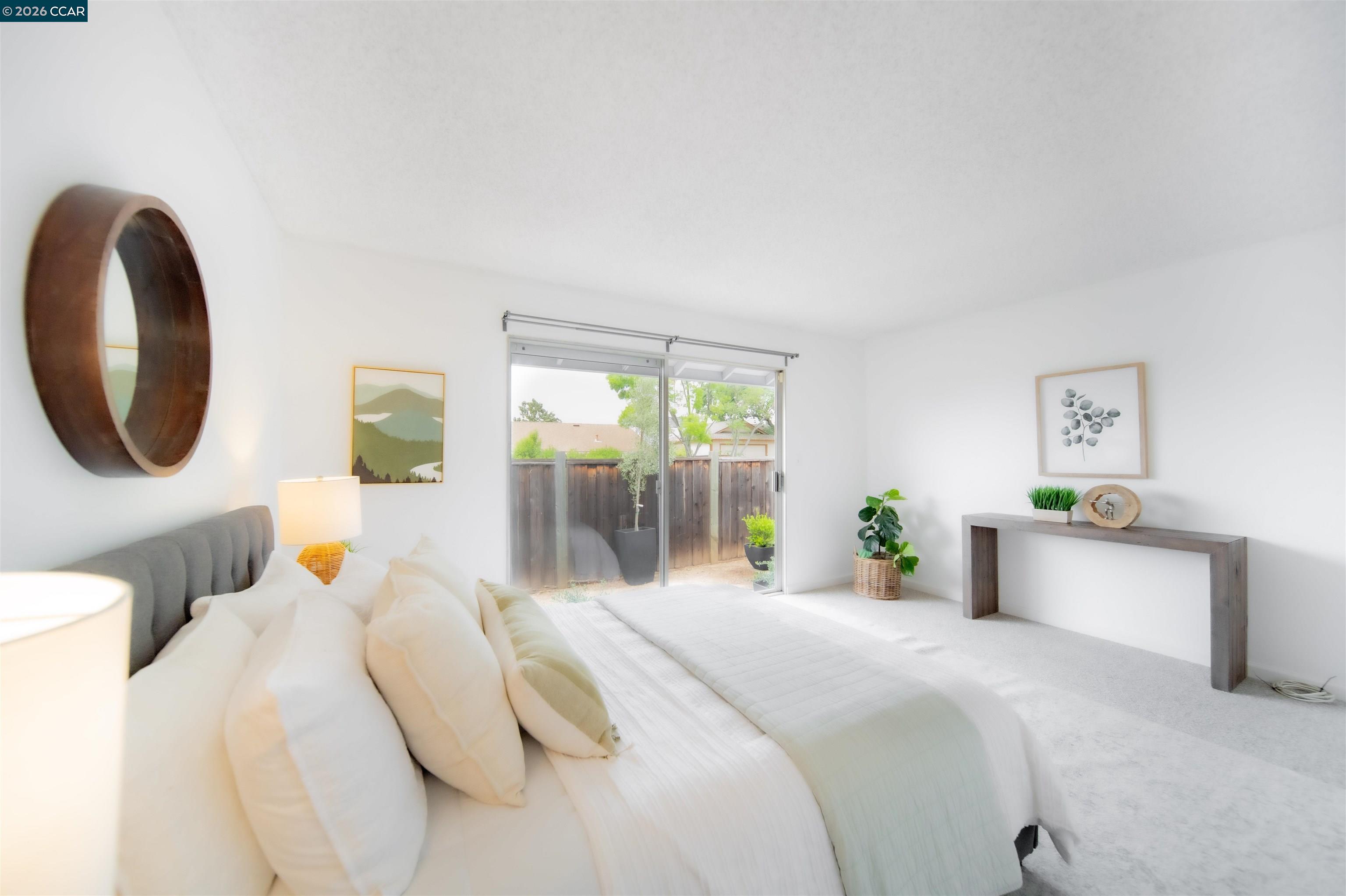 5581 Gonzalez Court Concord, CA 94521 - Photo 26 of 43 a bedroom with a bed a mirror and a large window