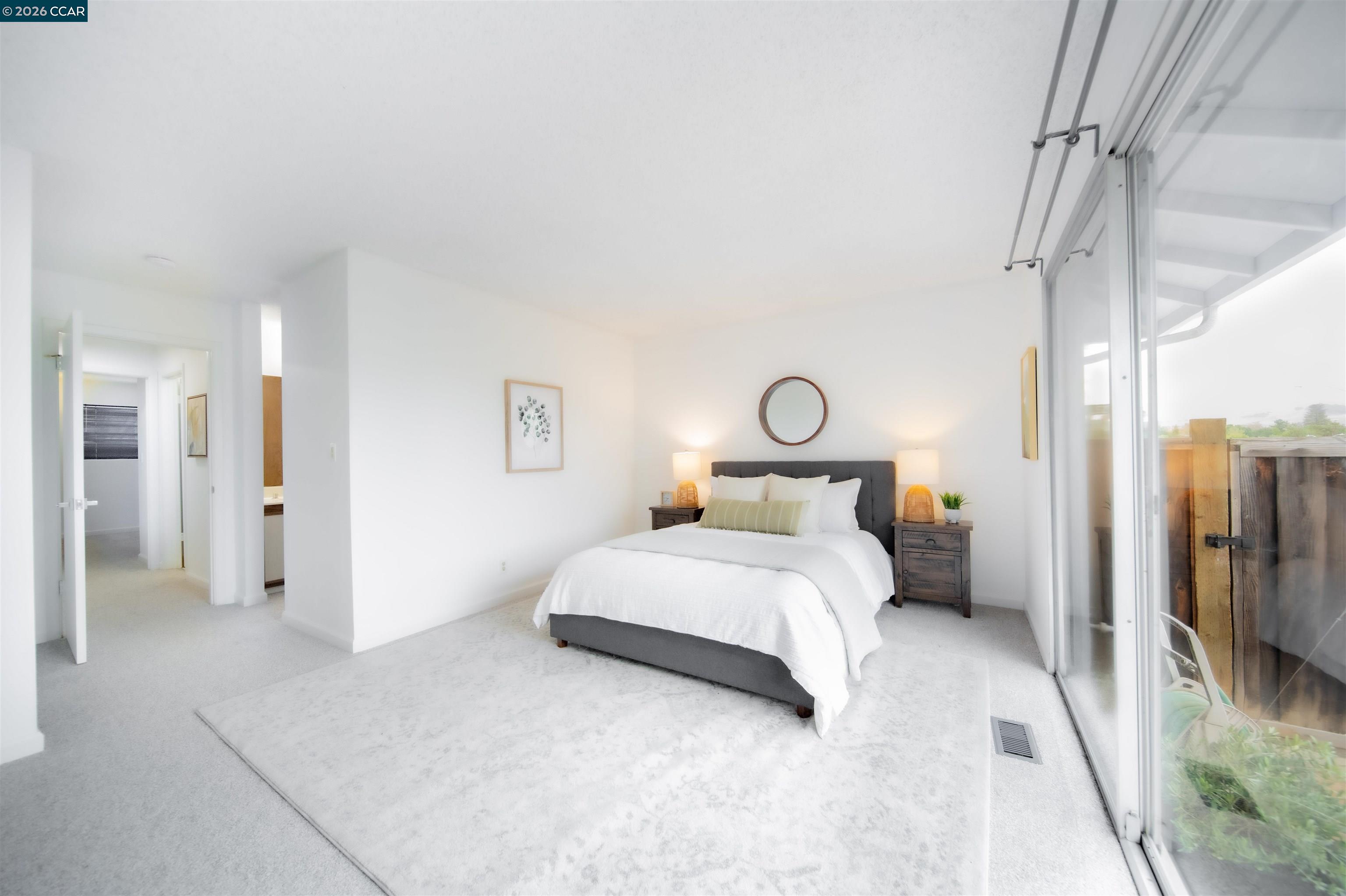 5581 Gonzalez Court Concord, CA 94521 - Photo 27 of 43 a bedroom with a bed and a chandelier