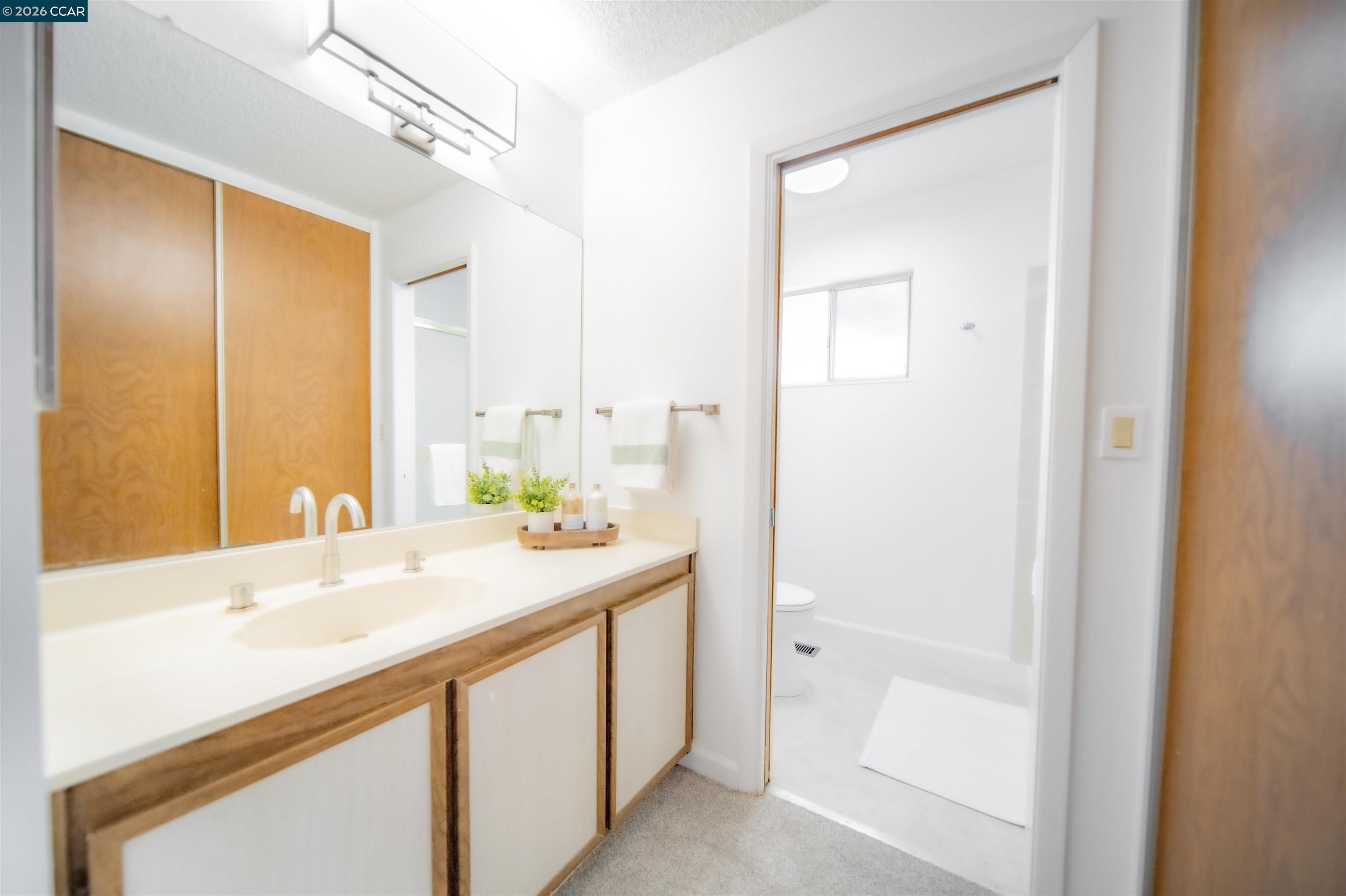 5581 Gonzalez Court Concord, CA 94521 - Photo 29 of 43 a bathroom with a sink a mirror and a shower
