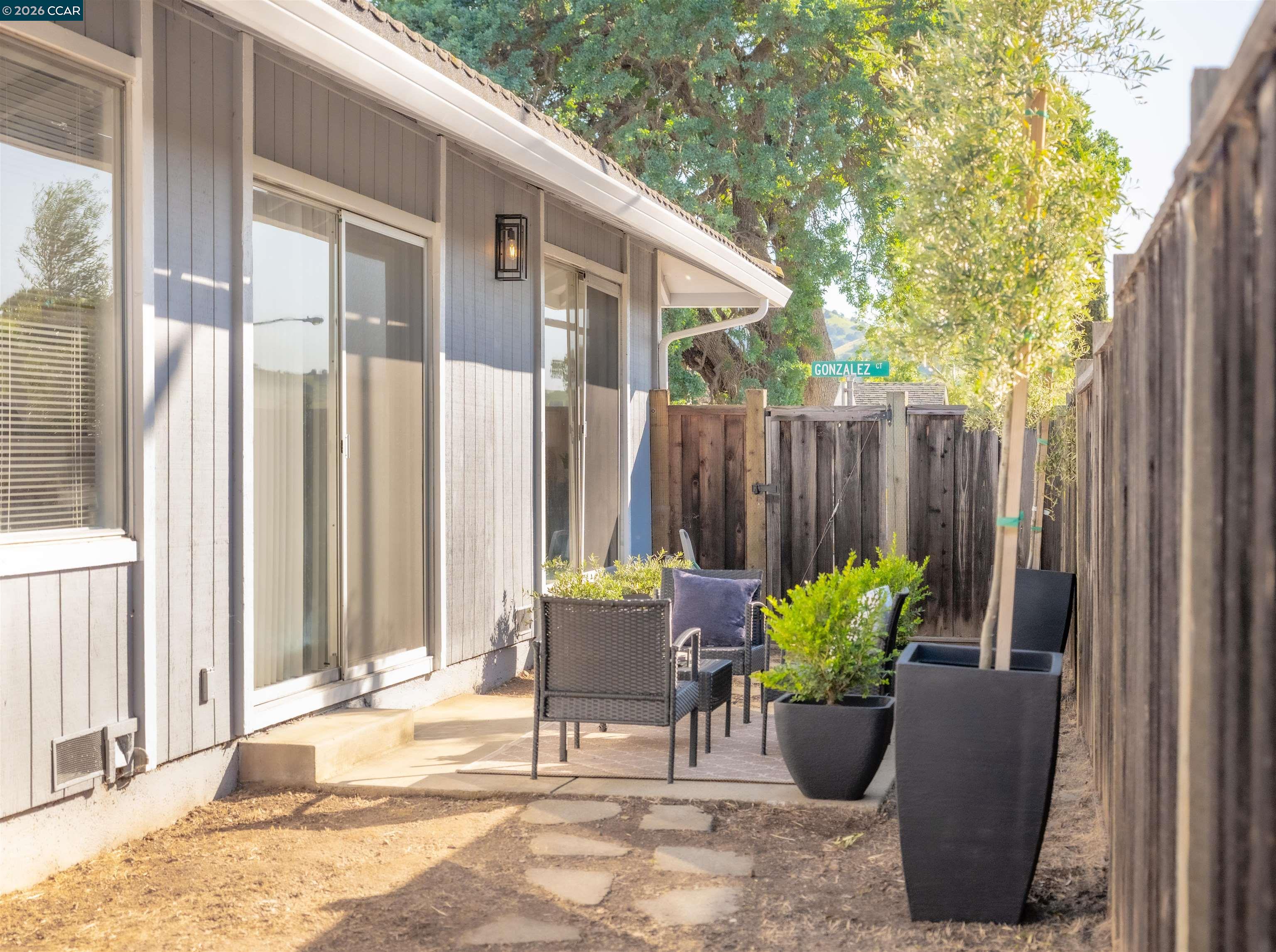 5581 Gonzalez Court Concord, CA 94521 - Photo 30 of 43 a view of a patio with chair and potted plants