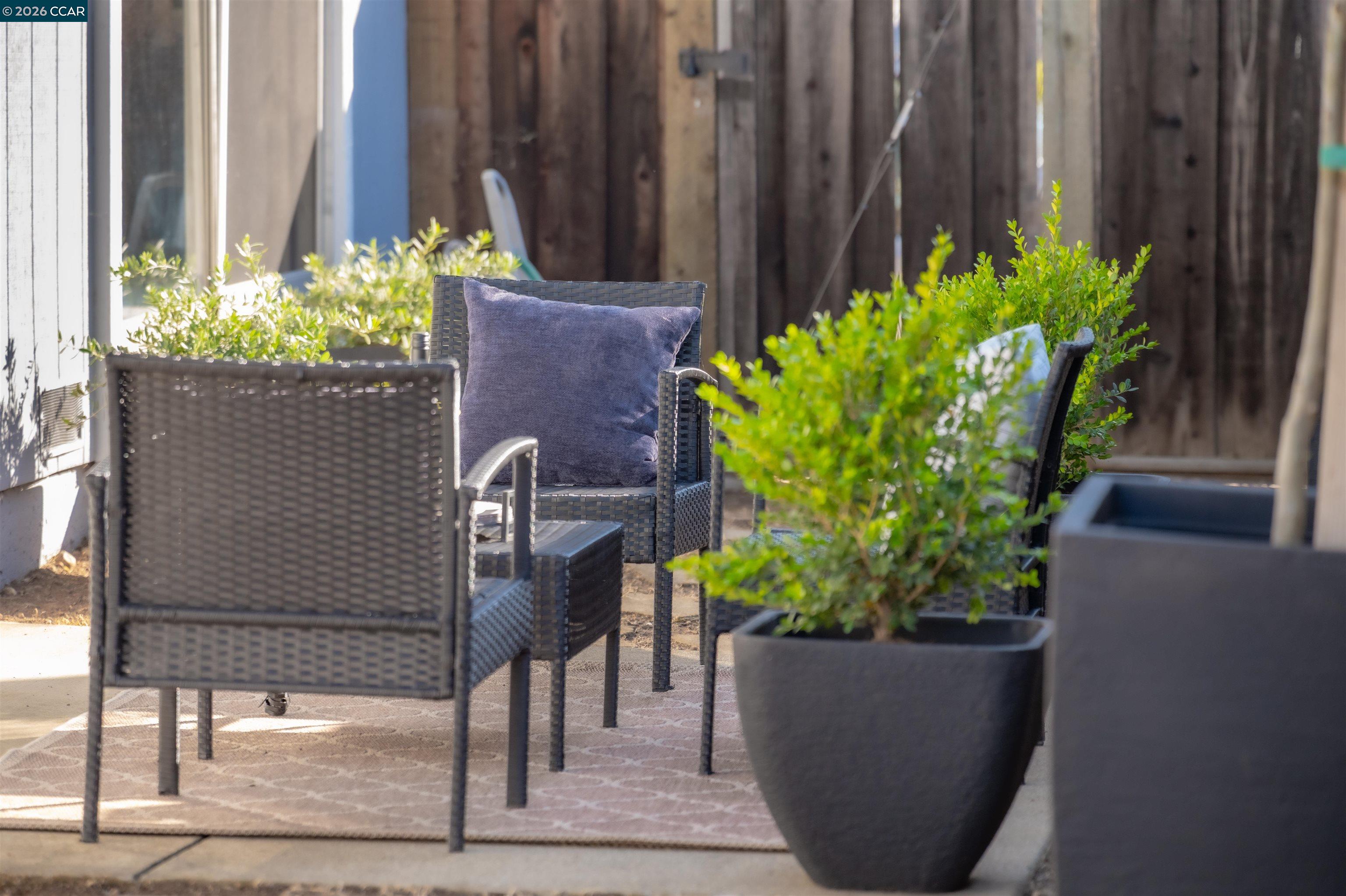 5581 Gonzalez Court Concord, CA 94521 - Photo 31 of 43 a table with chairs and a potted plant