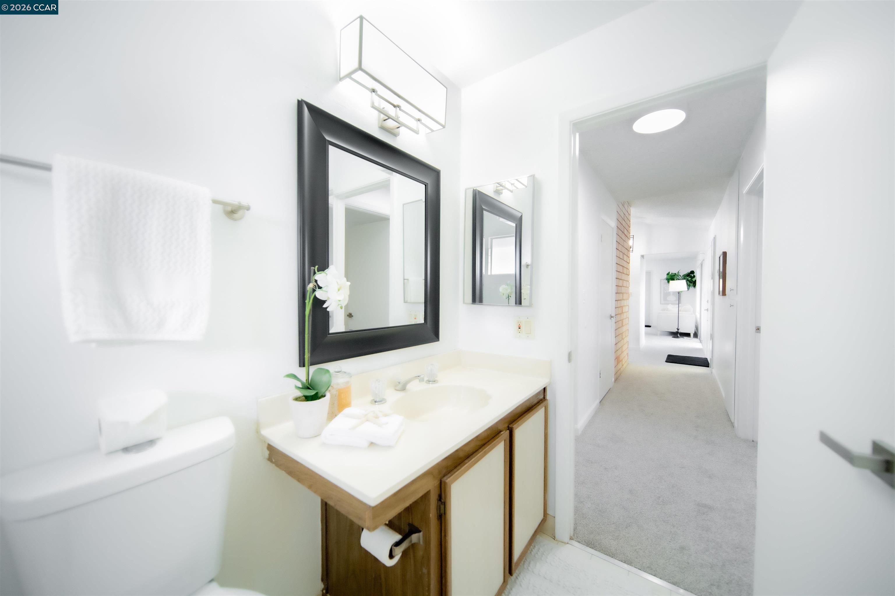 5581 Gonzalez Court Concord, CA 94521 - Photo 35 of 43 a bathroom with a sink a toilet and mirror