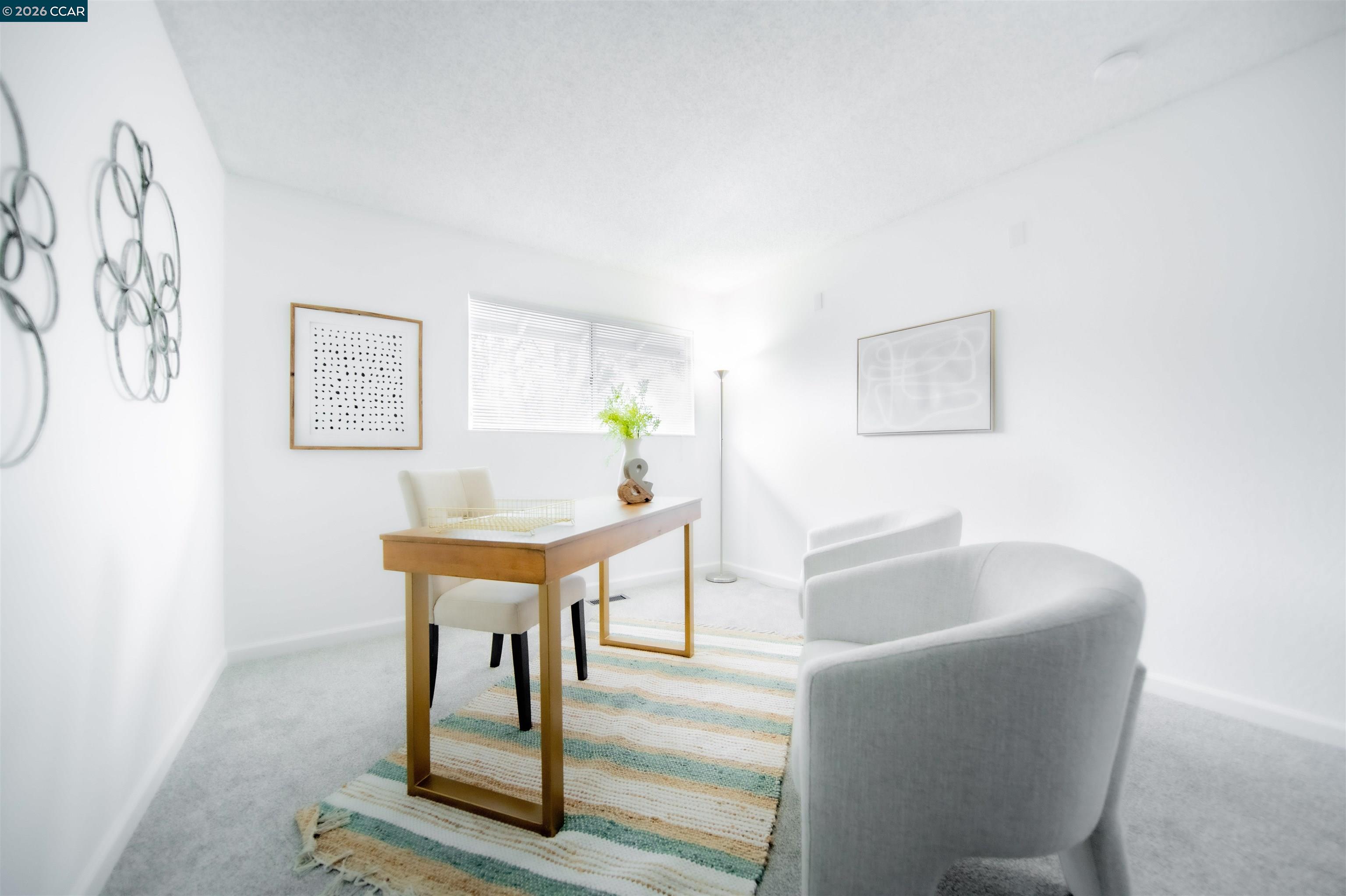 5581 Gonzalez Court Concord, CA 94521 - Photo 37 of 43 a living room with furniture a table and paintings on the wall