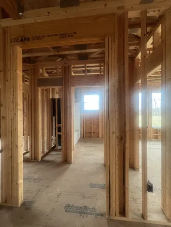 a view of a hallway with wooden cabinets