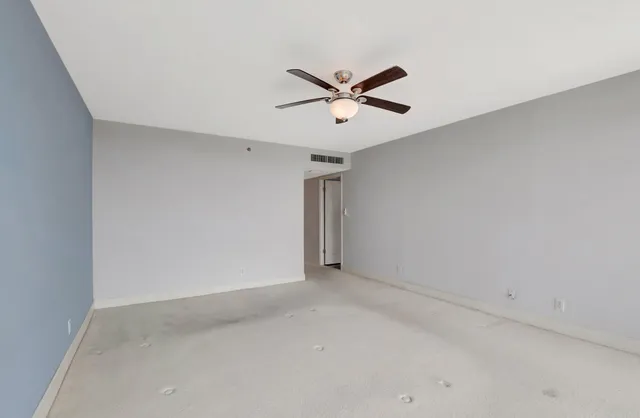 an empty room with windows and pool table