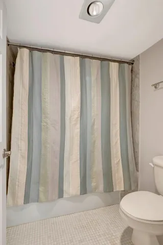 a bedroom with a bed a table and a large window