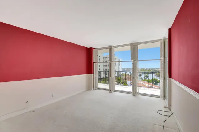 an aerial view of ocean and residential houses with outdoor space