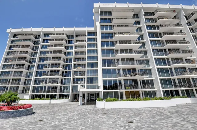 a large white kitchen with a large window