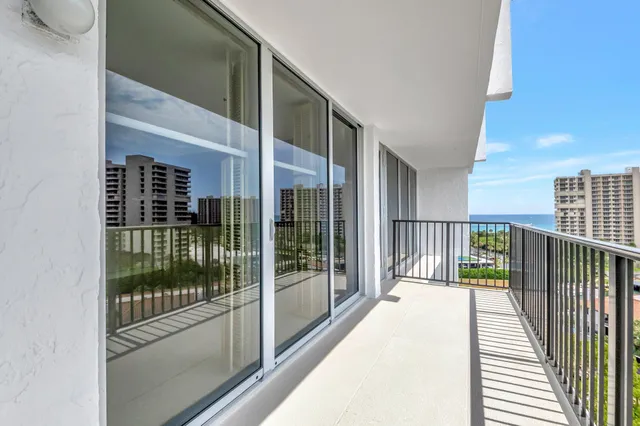 a view of a balcony with floor to ceiling window with wooden floor