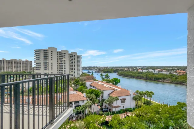 a kitchen with stainless steel appliances granite countertop a sink dishwasher and white cabinets with wooden floor