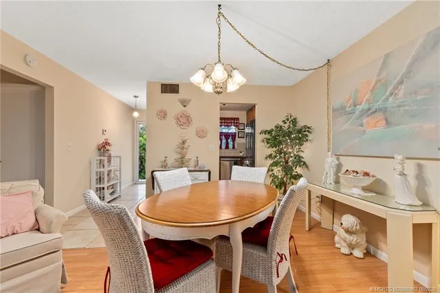 a dining room with furniture a chandelier and window