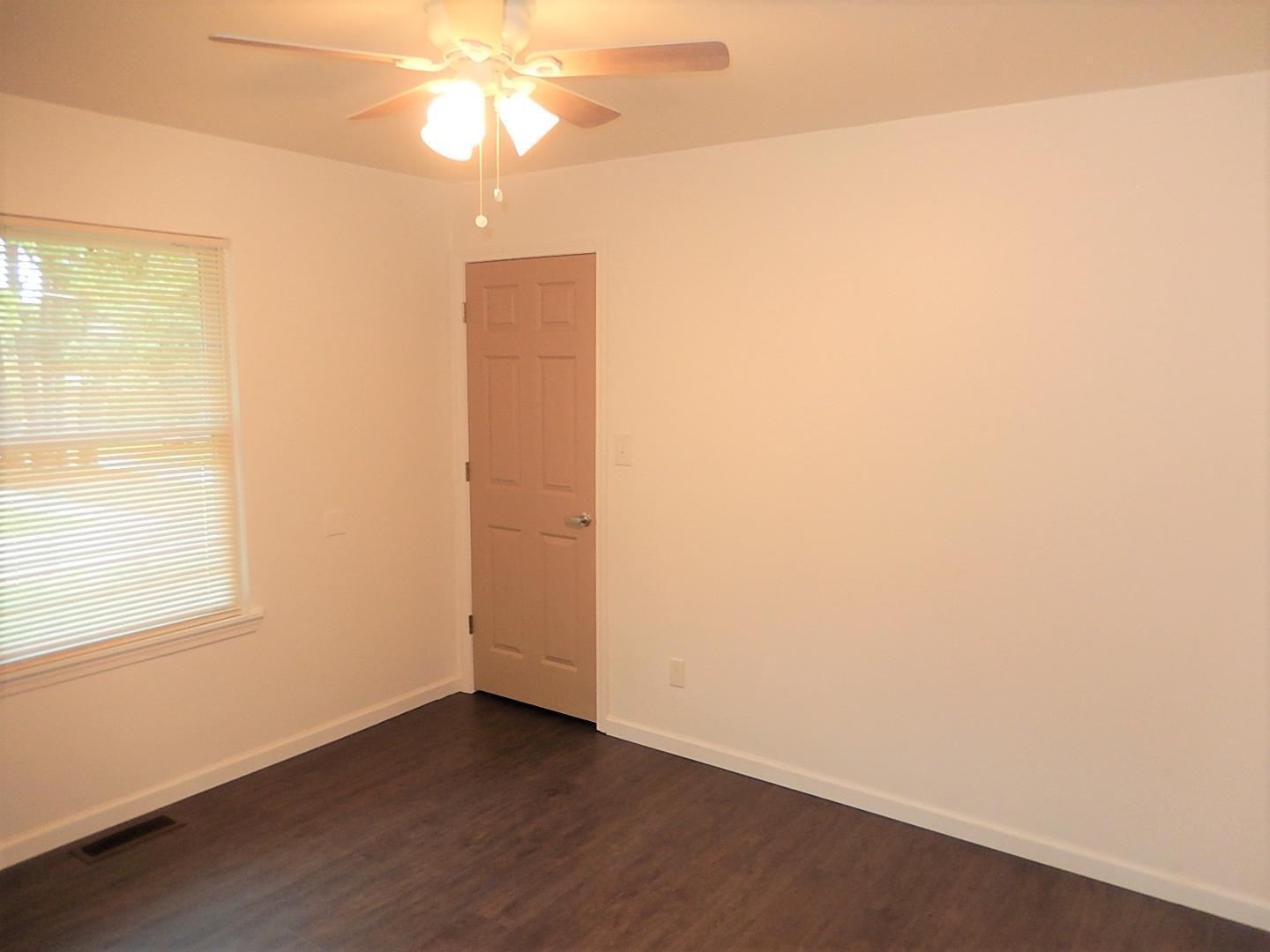 1016 Caspan Street Raleigh, NC 27610 - Photo 12 of 27 an empty room with a window and wooden floor
