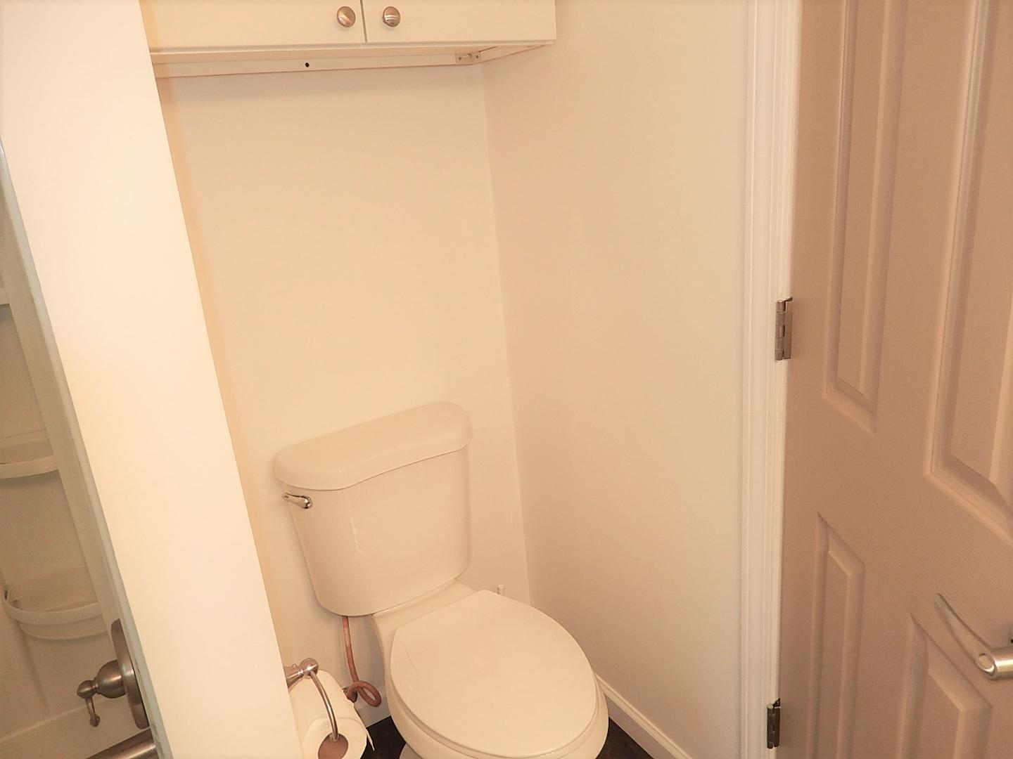 1016 Caspan Street Raleigh, NC 27610 - Photo 16 of 27 a white toilet sitting next to a shower