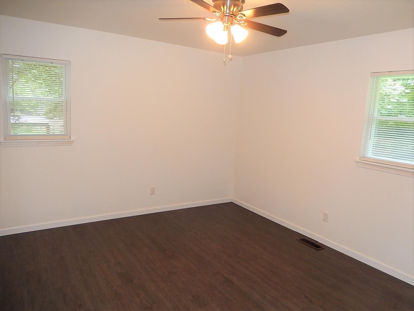 1016 Caspan Street Raleigh, NC 27610 - Photo 17 of 27 an empty room with wooden floor and windows