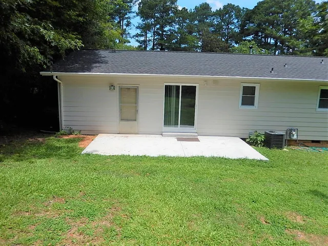 a view of a house with a yard and a garage