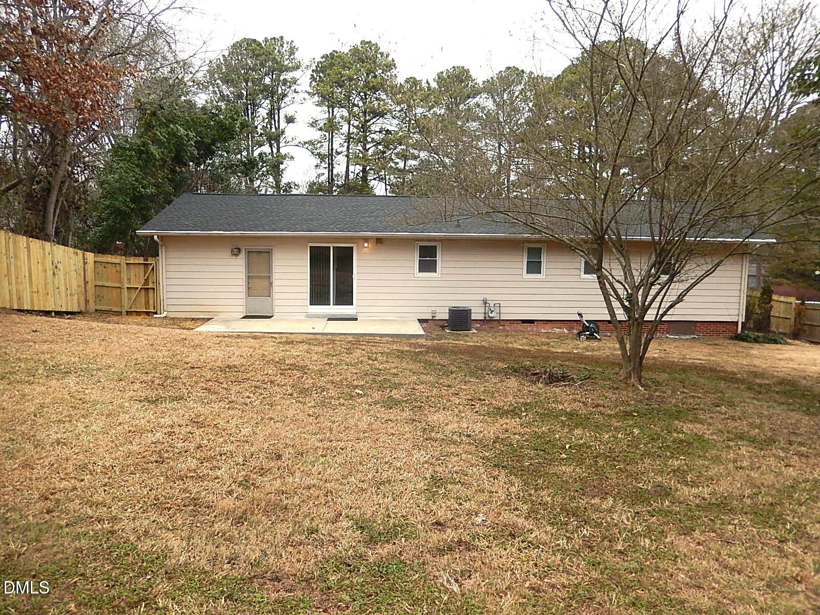 1016 Caspan Street Raleigh, NC 27610 - Photo 25 of 27 a front view of house with yard and trees around