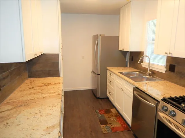a utility room with cabinets washer and dryer