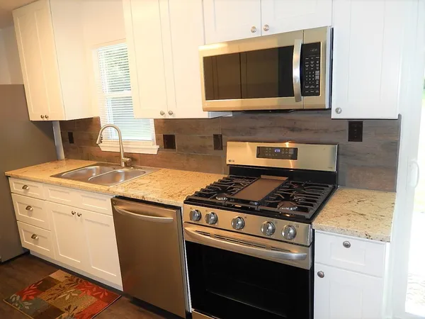 a kitchen with a stove and a microwave